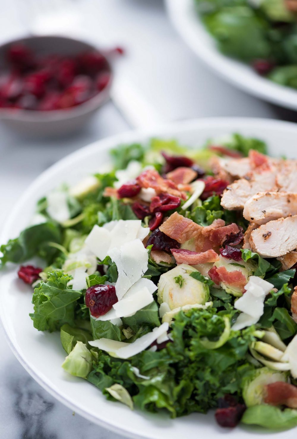 Shredded Brussels Sprouts salad, with bacon, healthy, cranberries, recipe, gluten free, dried cranberries, cheese, parmesan,