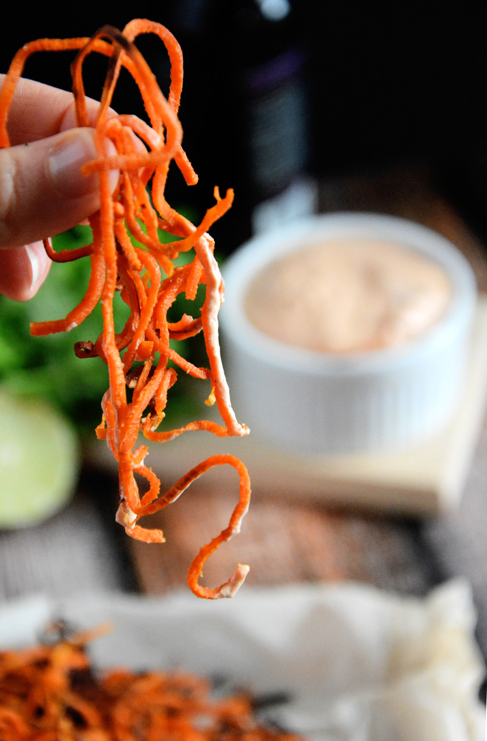 Homemade Sweet Potato Curly Fries with Chipotle Lime Aioli are a healthier spin off the classic sweet potato fry. Crispy, sweet, spicy and irresistible! #paleo #healthier #spiralized #fries