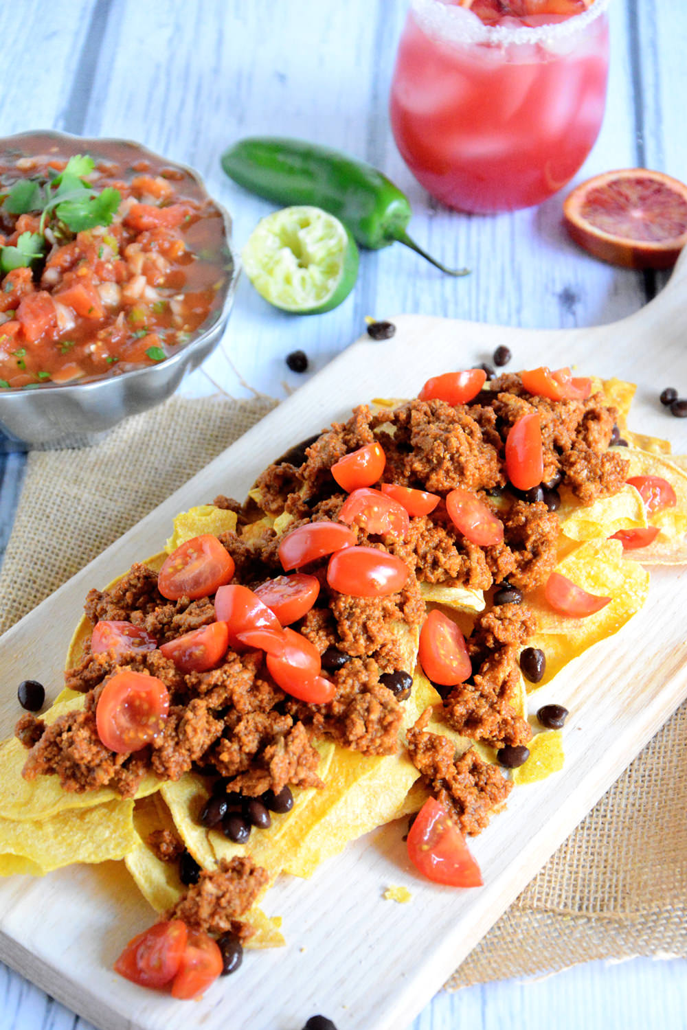 Quick and flavorful Enchilada Nachos with spiced, lean ground turkey makes these loaded nachos a crowd pleaser! 