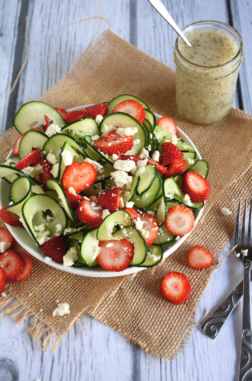 A refreshing and crisp salad with spiralized cucumbers, juicy strawberries and feta salad all topped with a fruity poppyseed dressing!