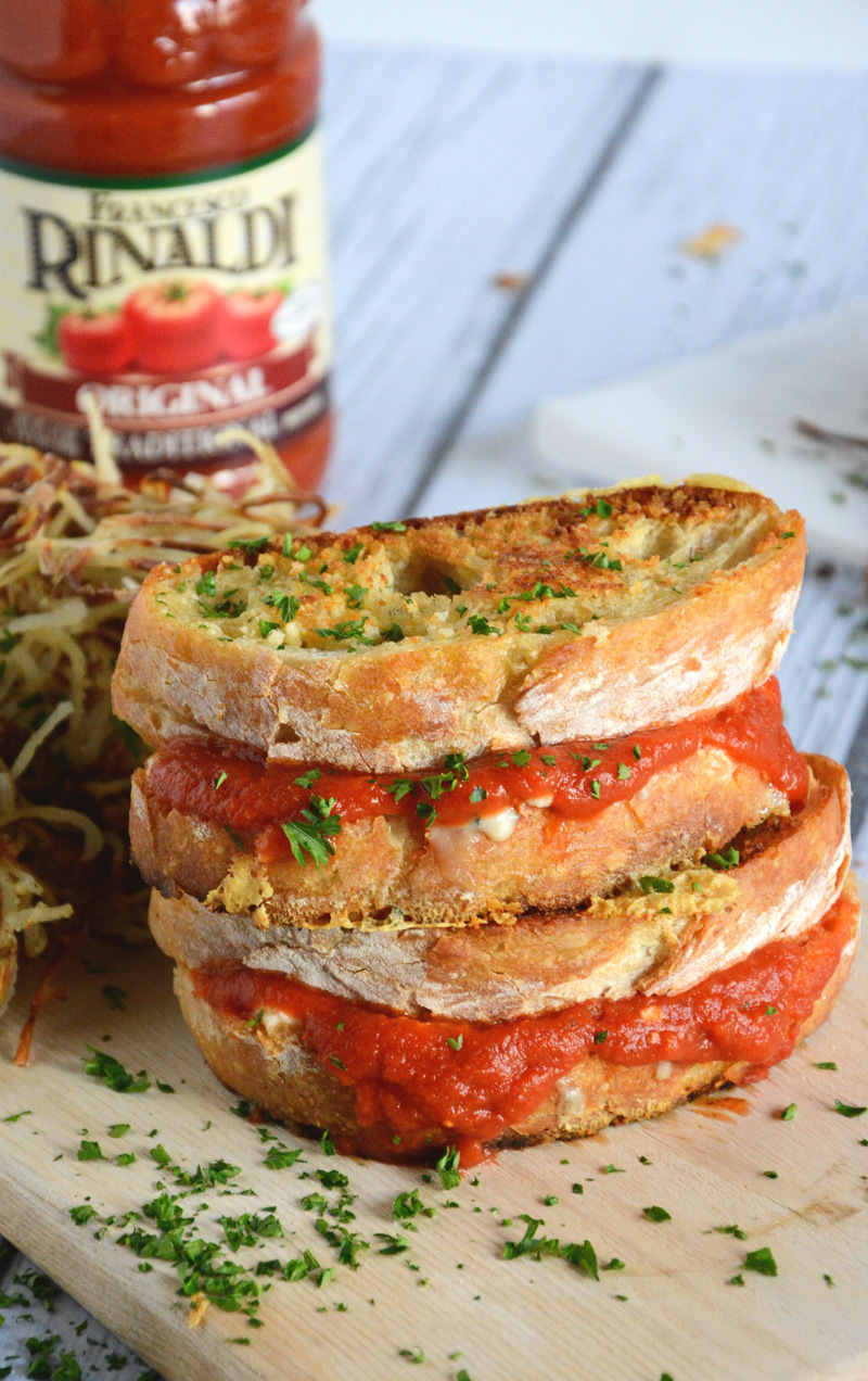 A gooey triple grilled cheese filled with two cheeses and warm marinara sauce with a crunchy parmesan crust!