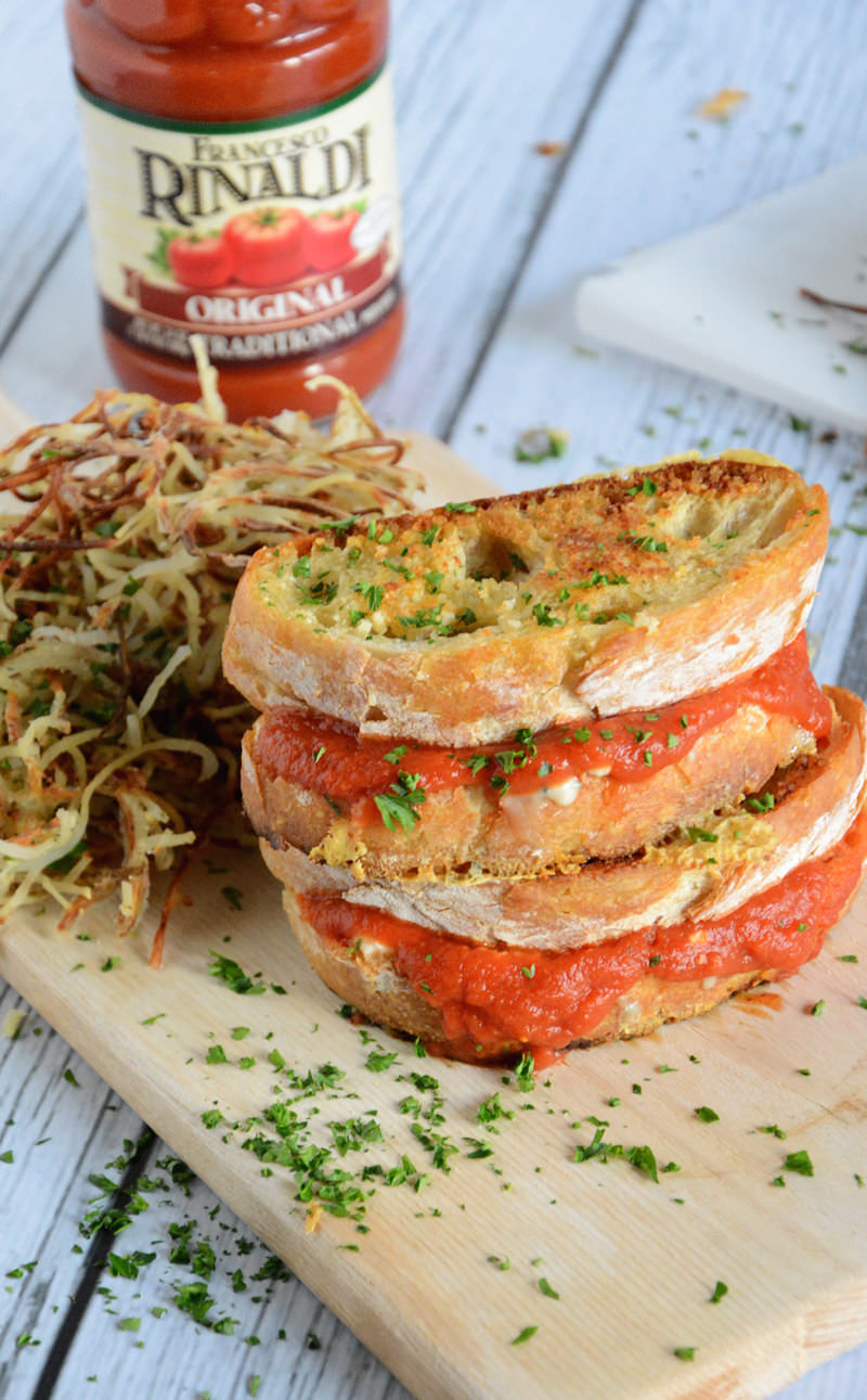 A gooey triple grilled cheese filled with two cheeses and warm marinara sauce with a crunchy parmesan crust!