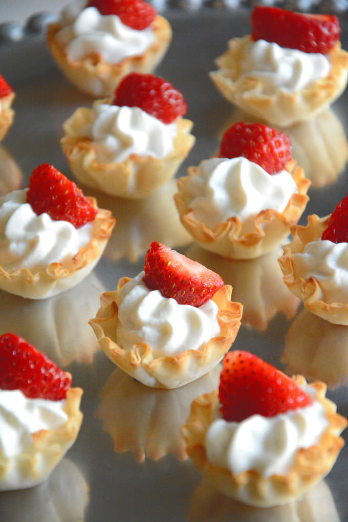 {5 Ingredient} Strawberries and Cream Tarts | A guilt free, no bake dessert with vanilla greek yogurt custard, phyllo cups & strawberries! 