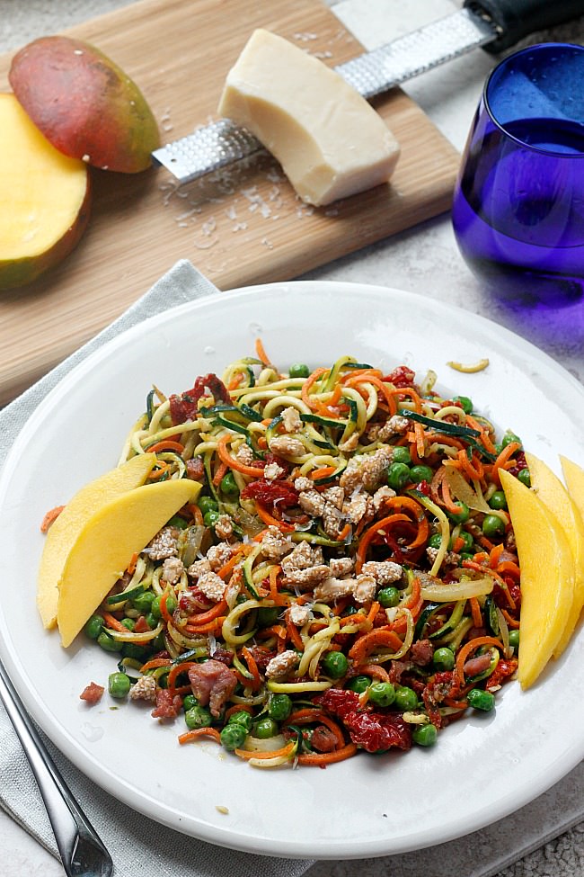 A 30 minute meal that is bursting with flavor from zucchini noodles, fresh vegetables and topped with pesto and mango! Summer flavors right here! #spiralized #lowcarb #zoodles 