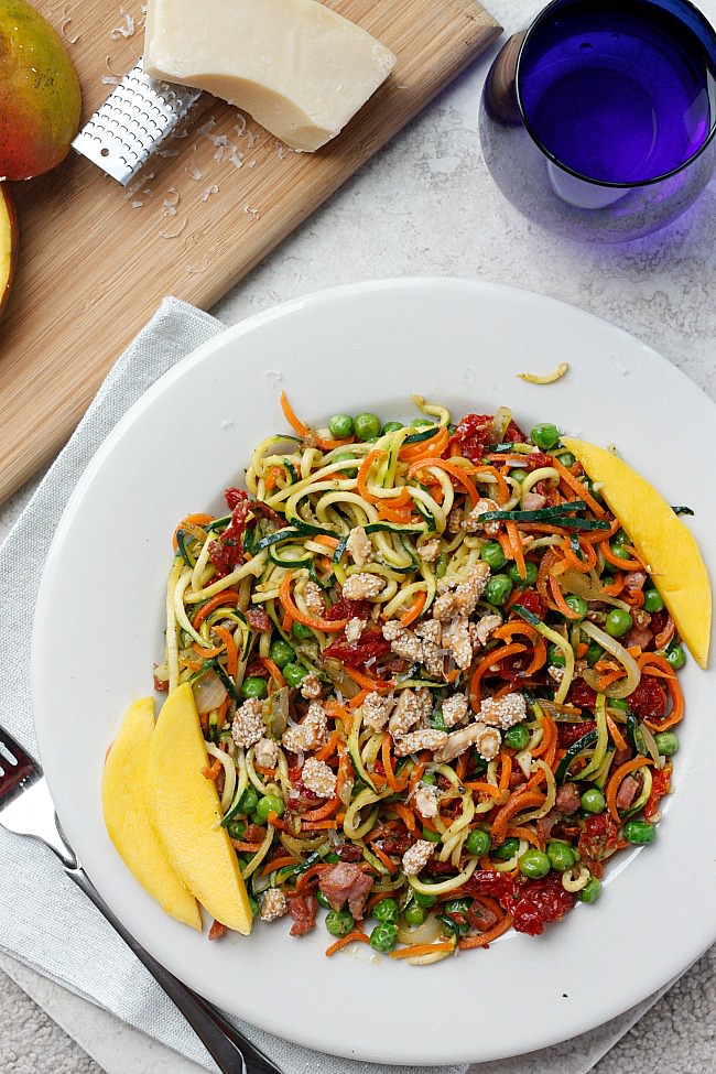 A 30 minute meal that is bursting with flavor from zucchini noodles, fresh vegetables and topped with pesto and mango! Summer flavors right here! #spiralized #lowcarb #zoodles 