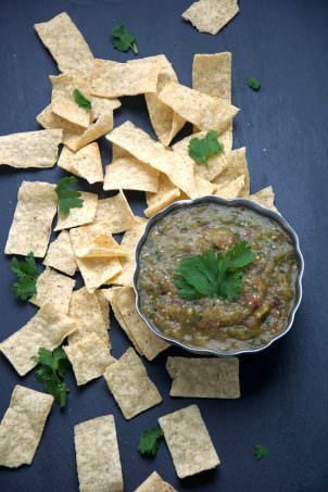 A simple salsa verde of roasted tomatillos, red onions and hatch chiles to make a sweet and smoky salsa that is perfect to any salty tortilla chip!
