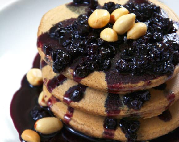 Pure grown up, peanut butter and jelly bliss right here with oat pancakes filled with greek yogurt and honey roasted peanut butter and topped with a simple two ingredient blueberry glaze!