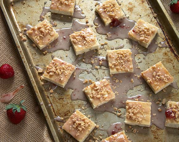 Two classic cookies come together in this lighter and sweet shortbread sugar cookie! And drizzled with a simple strawberry toffee glaze; they will be a hit this holiday season!