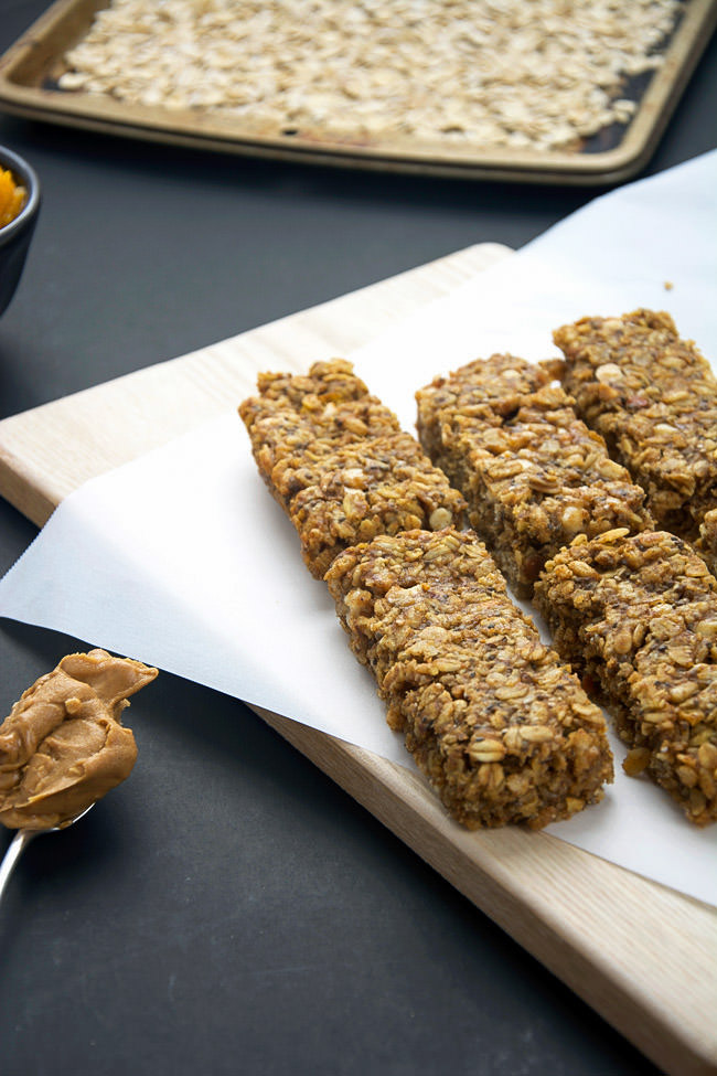 A homemade granola bar bursting with fall flavors of pumpkin pie spice, cinnamon and vanilla yogurt chips!  These bars are full of flavor, moist and healthy so you can indulge this holiday season!