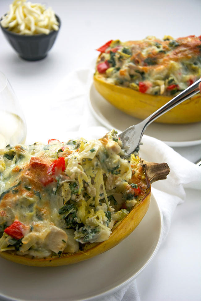 Stuffed spaghetti squash filled with a lightened up version of a favorite dip - spinach and artichoke! A super simple, yet healthy dinner that perfect any night of the week!