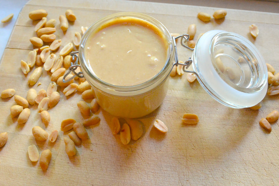 Homemade coconut peanut butter could not be easier! Roasted peanuts and coconut oil are blended until velvety - grab a spoon and dip in! #peanutbutter #homemade #glutenfree #coconut 