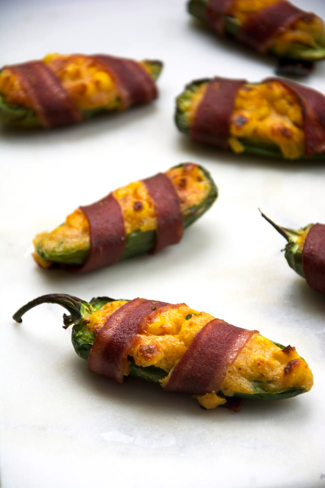 Cheesy Corn Stuffed Jalapenos will help you get out of that game day grub rut! Cheesy cornbread is stuffed into jalapenos, wrapped in turkey bacon then baked! Surprisingly healthy and completely irresistible! #appetizer #stuffedjalapenos #cheesycorn #glutenfree
