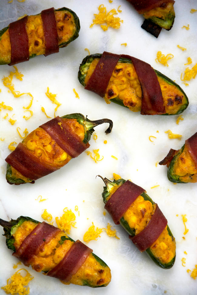 Cheesy Corn Stuffed Jalapenos will help you get out of that game day grub rut! Cheesy cornbread is stuffed into jalapenos, wrapped in turkey bacon then baked! Surprisingly healthy and completely irresistible! 
