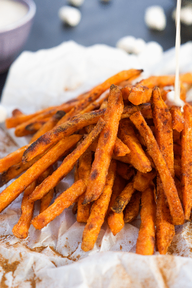 Cinnamon Sugar Sweet Potato Fries are cinnamon and sugar dusted and served with a homemade toasted marshmallow sauce! They are not your typical side of fries, rather a upgraded dessert! #sweetpotatofries #marshmallows #  #GameTimeGrub