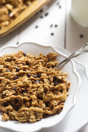 A lighter spin on granola that is filled with peanut butter and chocolate chips! This Lighter Peanut Butter Cup Granola tastes like a bite of your favorite candy!