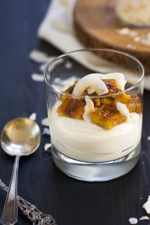 Skinny Banana Fosters Cheesecake Parfaits are madeover with cheesecake flavored greek yogurt, caramelized bananas and toasted coconut for a healthy, dessert inspired breakfast!