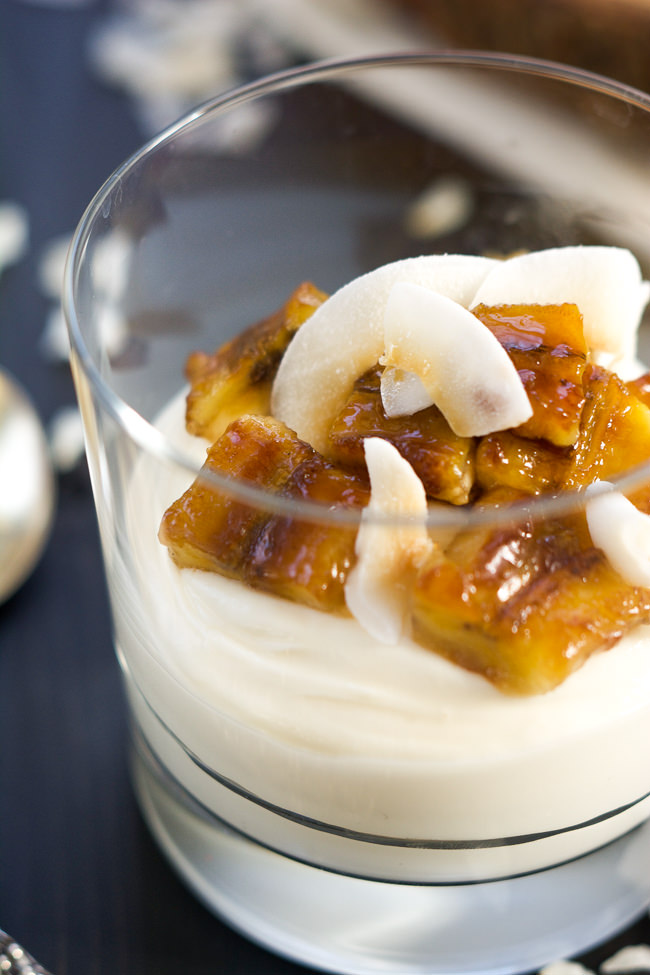 Skinny Banana Fosters Cheesecake Parfaits are madeover with cheesecake flavored greek yogurt, caramelized bananas and toasted coconut for a healthy, dessert inspired breakfast! 