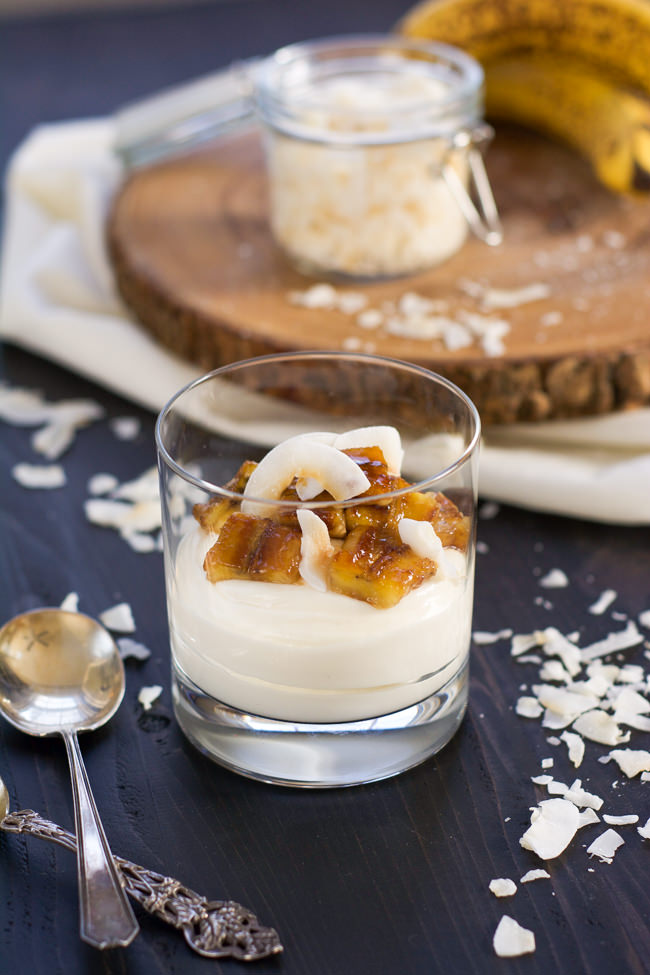 Skinny Banana Fosters Cheesecake Parfaits are madeover with cheesecake flavored greek yogurt, caramelized bananas and toasted coconut for a healthy, dessert inspired breakfast! 