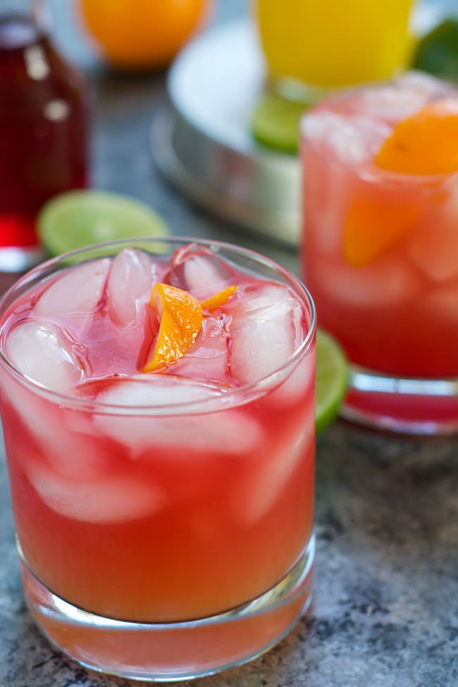 This Skinny Hurricane Cocktail is a healthier version of the classic Mardi Gras drink is filled with orange and cranberry juice and finished with light rum for a refreshing cocktail! #MardiGras #Skinny #Cocktail #Beverage