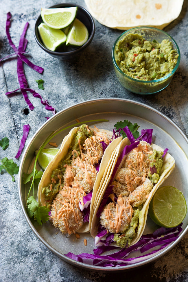 A skinny makeover of a restaurant classic! Skinny Baked Bang Bang Shrimp Tacos combine two of my favorites into one flavorful dish that is ready in 20 minutes! 