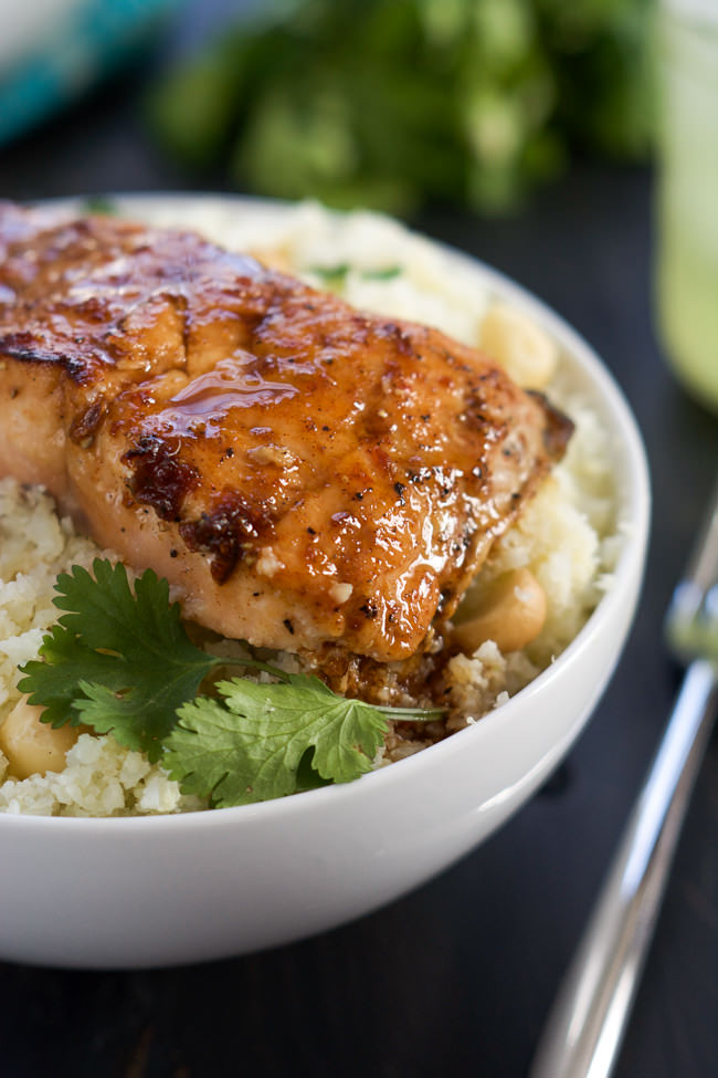 Agave Chipotle Glazed Salmon is the best of both worlds - sweet and savory! Tender salmon coated in a homemade sauce of agave, chipotle peppers, garlic and lime and served over low carb Macadamia Cauliflower Rice!