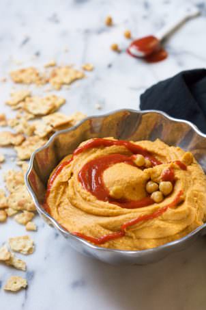 A sweet and spicy combo is the perfect pair in this Honey Sriracha Hummus that takes minutes to throw together!