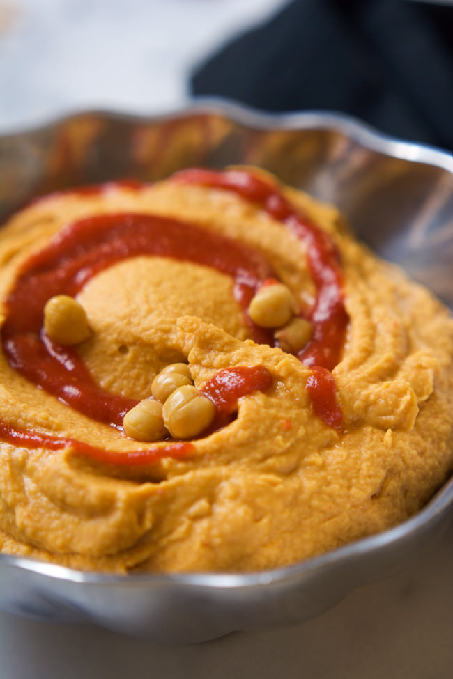 A sweet and spicy combo is the perfect pair in this Honey Sriracha Hummus that takes minutes to throw together!  