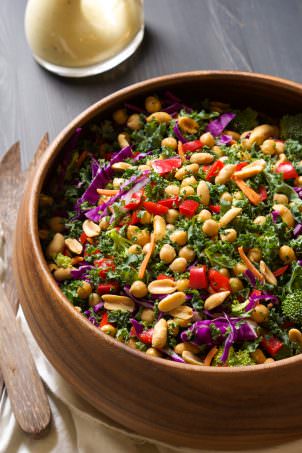 This colorful and nutrient dense Power Kale Salad is filled with crunchy vegetables, drizzled with a peanut dijon dressing and topped with salty peanuts! The perfect salad to fuel you up!