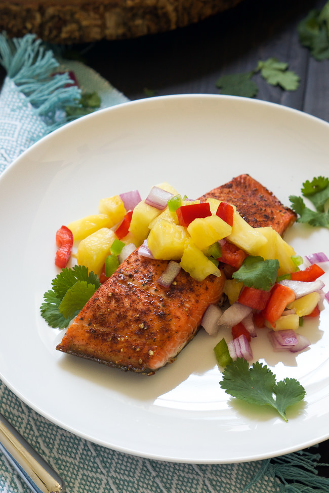 Chile spiced salmon is broiled to perfection, leaving a spicy and sweet crust on top and garnished with a fiery pineapple salsa that comes together in minutes!