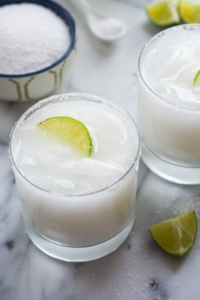 A tropical spin on the classic drink! These Skinny Coconut Margarita are made with lite coconut milk, coconut water, tequila blanco and triple sec for a refreshing cocktail! 