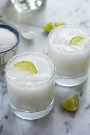 A tropical spin on the classic drink! These Skinny Coconut Margarita are made with lite coconut milk, coconut water, tequila blanco and triple sec for a refreshing cocktail!