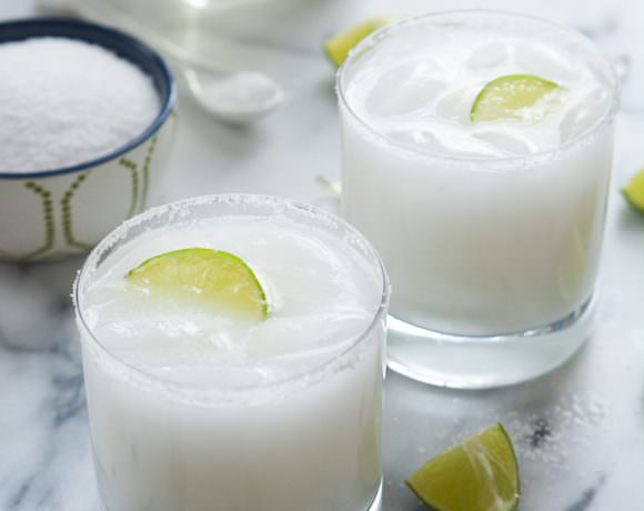 A tropical spin on the classic drink! These Skinny Coconut Margarita are made with lite coconut milk, coconut water, tequila blanco and triple sec for a refreshing cocktail!