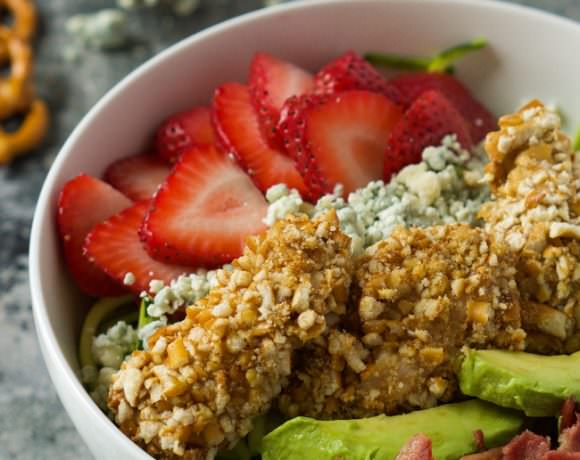 A fresh and summery salad that is slightly sweet and spicy all in the same bite! This Strawberry & Honey Mustard Pretzel Chicken Cobb Salad will step up your dinner time salad in no time!