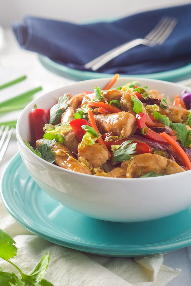 Honey Sriracha Chicken Rice Noodle Bowls are filled with chicken and stir fried vegetables, smothered in a sweet and spicy sauce; all over a big bowl of rice noodles!
