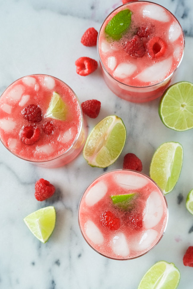 Raspberry Watermelon Margaritas are fruity and lighter thanks to fresh watermelon puree, a skinny simple syrup and the sparkling water topper! Perfect drink to kick your feet up with!