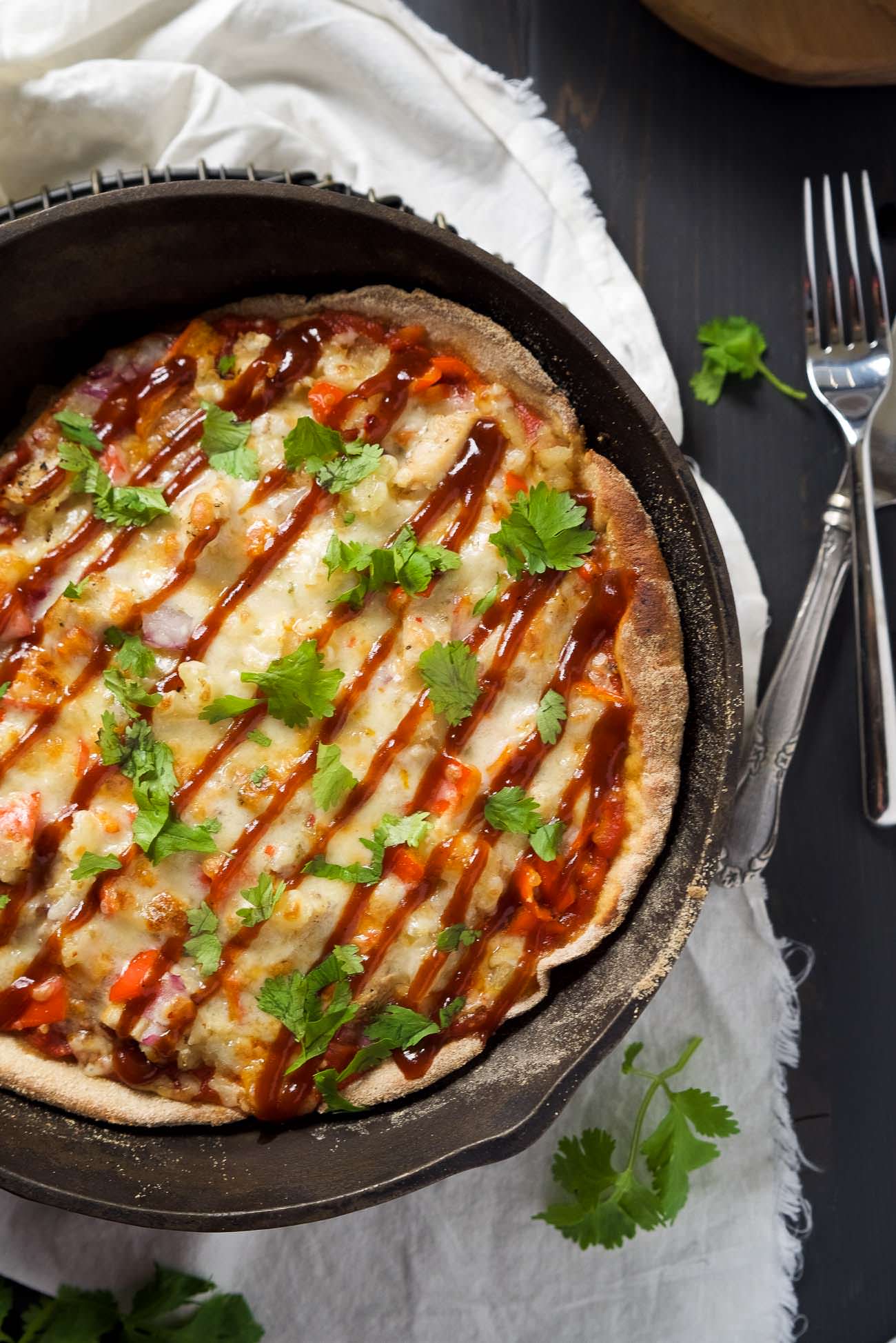 Cast Iron Skillet Chipotle BBQ Chicken Pizza is our new favorite way to make pizza! Sweet and spicy BBQ Chicken pizza has a crispy crust thanks to the cast iron skillet!