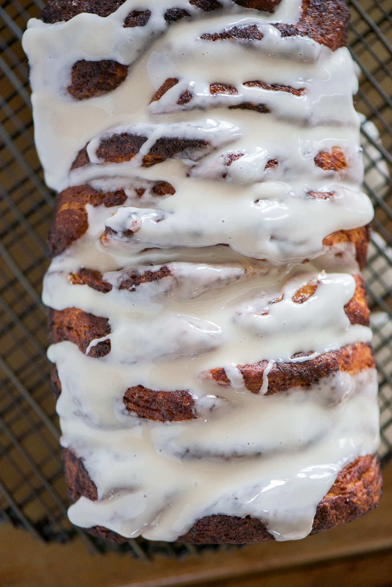Lightened Up Cinnamon Roll Pull Apart Bread as the ooey gooey flavor of your favorite sweet rolls, but in an easy and fun loaf form! Flakey biscuits layered with a lightened up cinnamon sugar mixture and drizzled in a delicious glaze! The perfect treat for any morning!