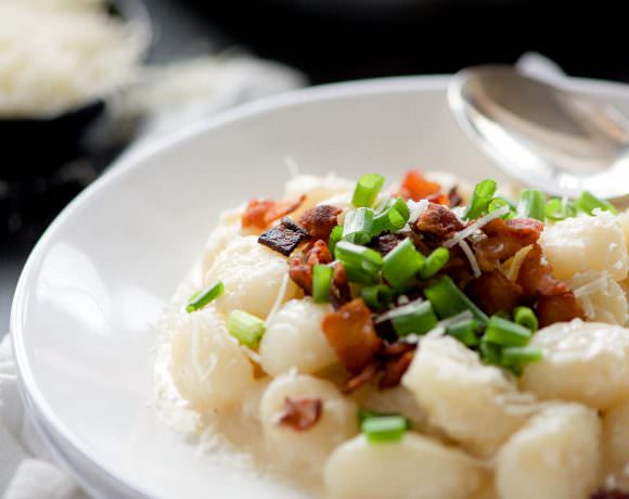 Loaded Baked Potato Gnocchi is a creamy one pot meal with a luscious parmesan sauce, crisp bacon and topped with green onions. A healthier and new take on a loaded baked potato!