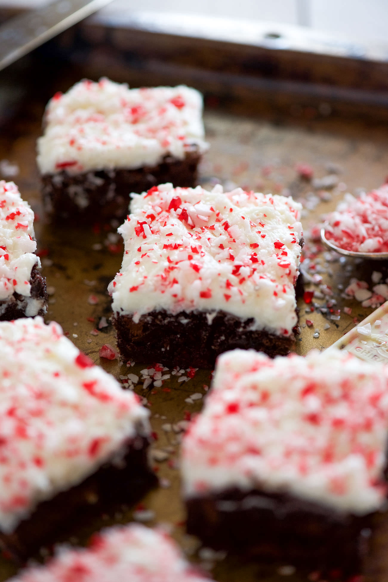 Peppermint White Mocha Brownies have a fudgy brownie base, filled with white chocolate and coffee! Then finished with a buttery peppermint frosting. A holiday dessert table must!