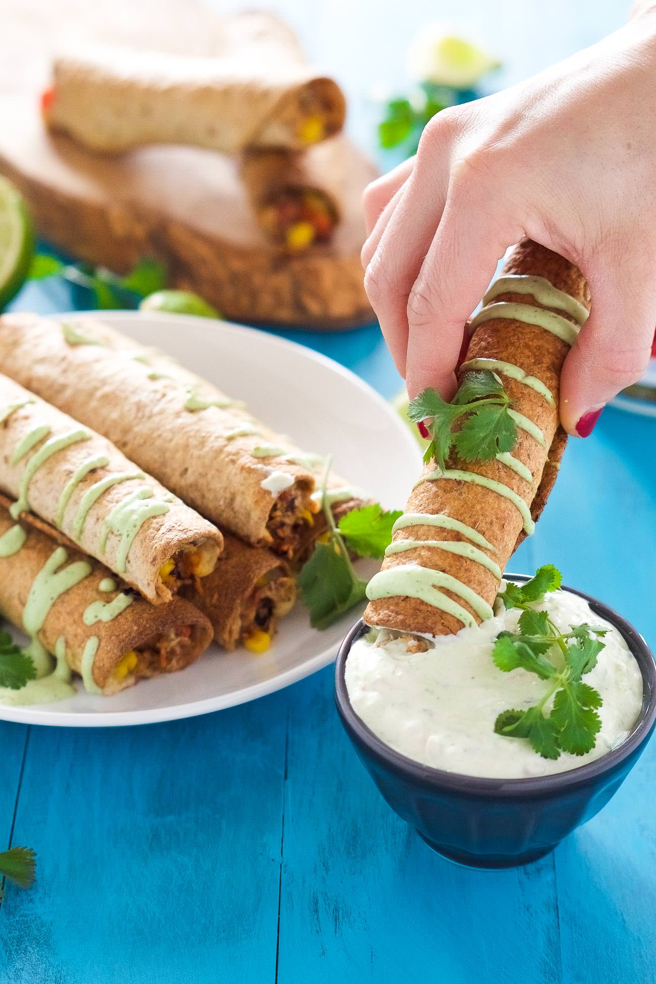 Cheesy Firecracker Baked Chicken Taquitos are a healthier alternative to their store bought sidekicks! Filled with gooey, spicy cheese, corn, chicken and peppers, they are super crispy thanks to a quick bake in the oven!