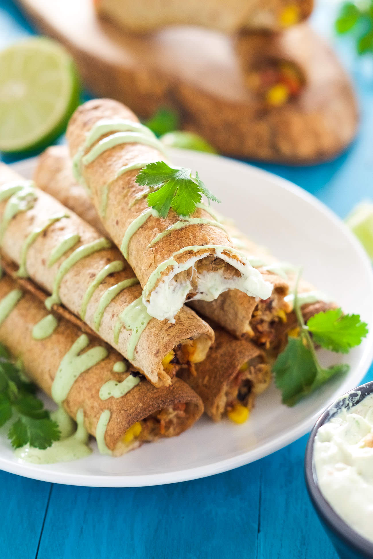 Cheesy Firecracker Baked Chicken Taquitos are a healthier alternative to their store bought sidekicks! Filled with gooey, spicy cheese, corn, chicken and peppers, they are super crispy thanks to a quick bake in the oven!