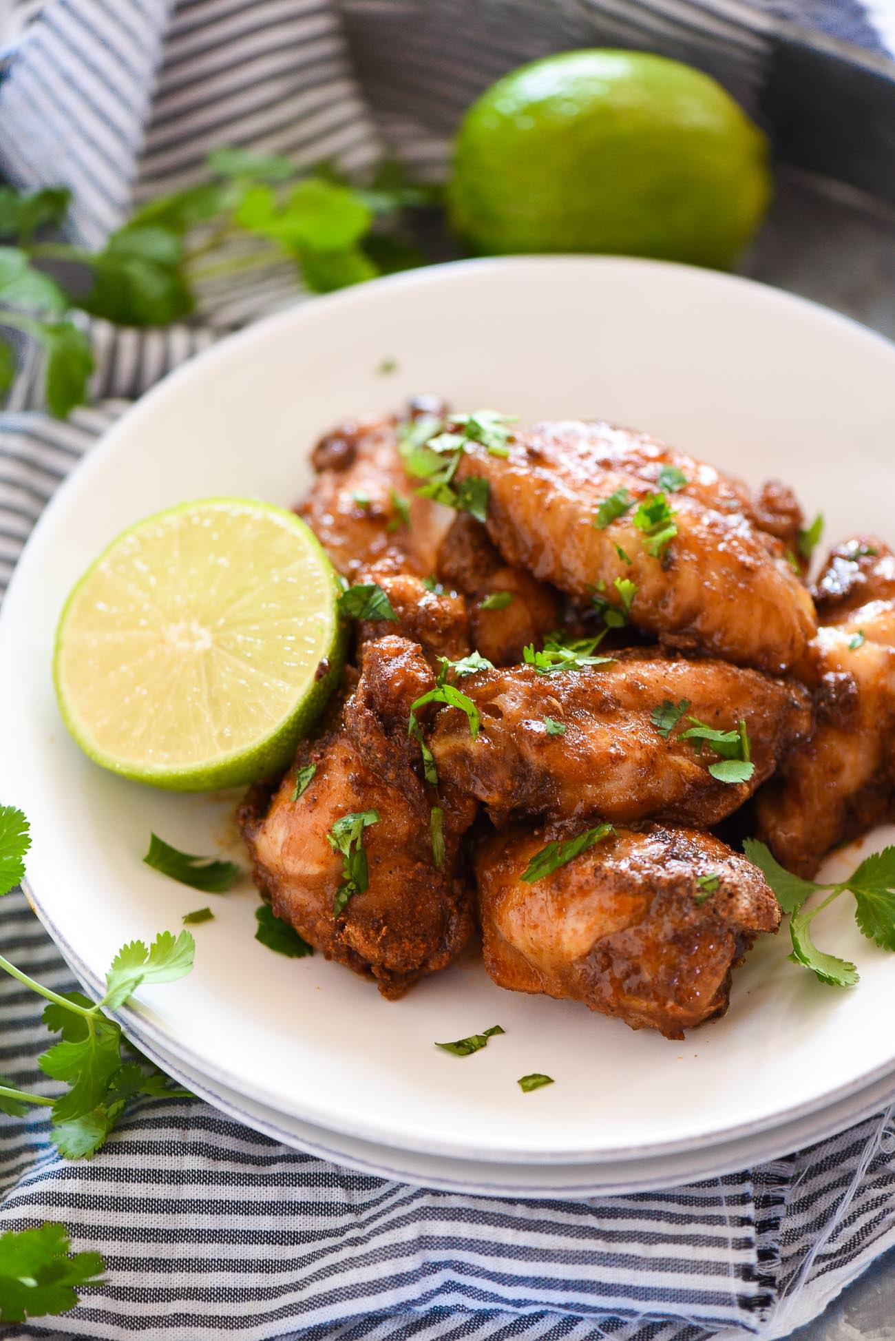 Honey Chipotle Crispy Baked Wings are an easy and healthy game dish! They are coated in a spicy chipotle rub, baked to crispy perfection then smothered in a honey lime sauce! 