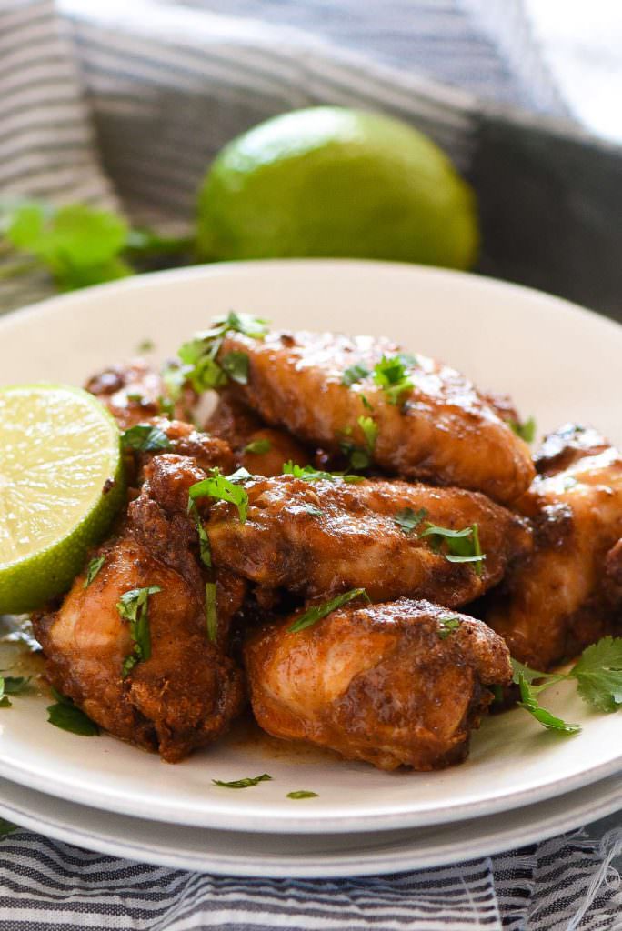 Honey Chipotle Crispy Baked Wings are an easy and healthy game dish! They are coated in a spicy chipotle rub, baked to crispy perfection then smothered in a honey lime sauce!