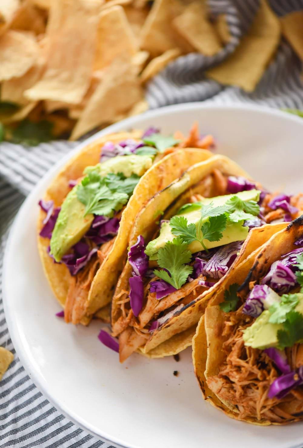 Slow Cooker Honey Chipotle Chicken Tacos are slightly sweet and slightly spicy! The slow cooked chicken is fall apart tender, juicy and full of chipotle and honey! Delicious in tacos or over lettuce for a lighter option!