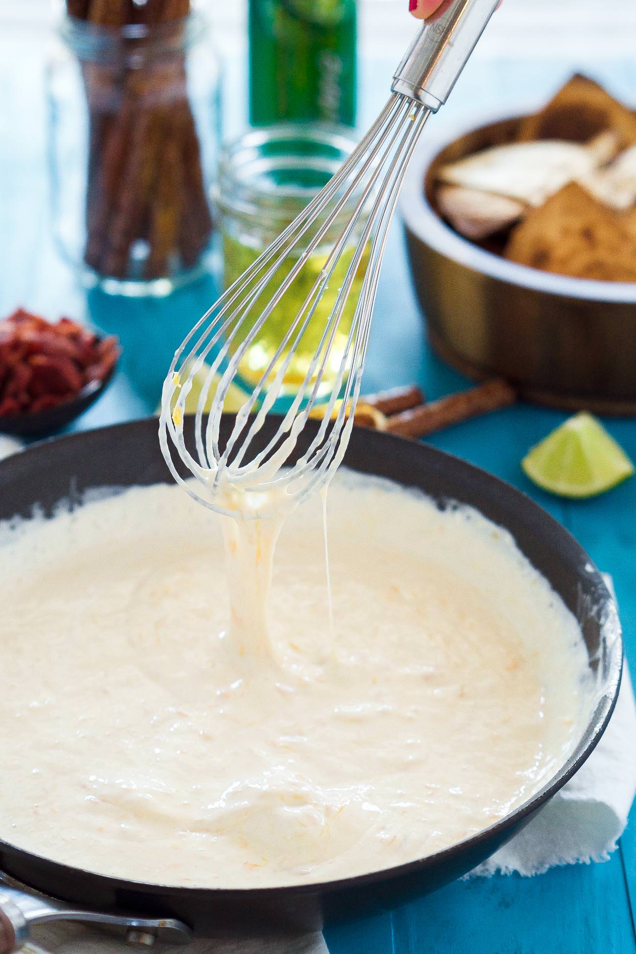 Sriracha Bacon Beer Cheese Dip is an irresistible, 4 ingredient appetizer that is creamy, cheesy, loaded with flavorful toppings and only takes only 15 minutes to make! It will be the hit at any party!