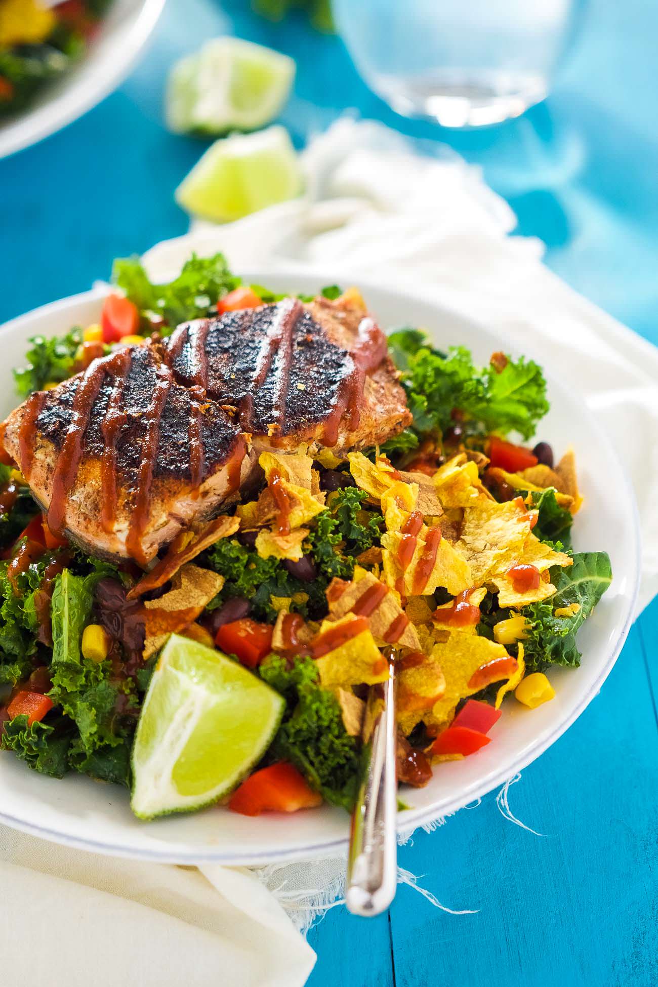 BBQ Salmon Kale Salad is a healthy and updated version of the classic BBQ salad! Filled with bold flavors, crunchy kale, crispy vegetables and all toss in a Honey Chipotle Vinaigrette! One easy to prepare salad you will fall in love with!