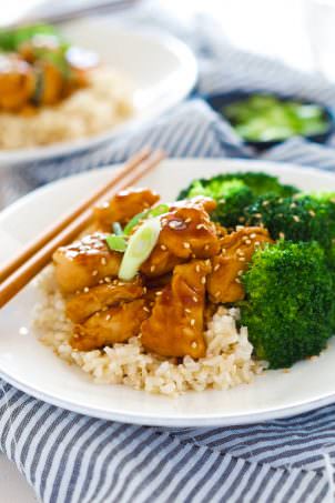 These delicious Skinny Honey Teriyaki Chicken Rice Bowls are a super quick dinner! Tender chicken is sauteed until juicy and simmered in a homemade, healthy teriyaki sauce. Served with fresh veggies and rice, you will forget all about takeout!