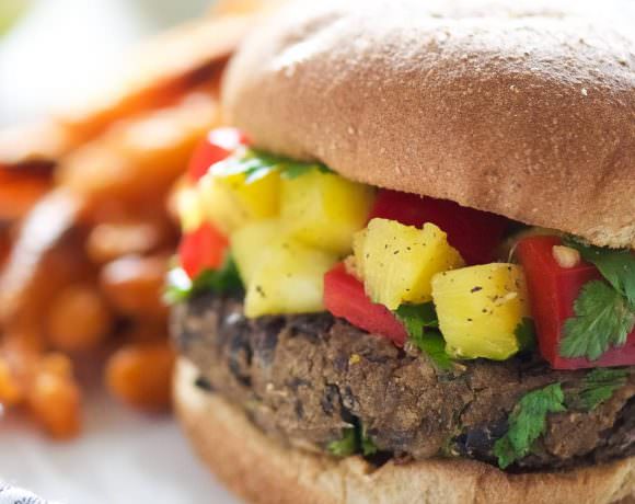 Take a bite out of these 20 Minute, homemade black bean burgers that come together with pantry items and topped with a sweet, pineapple salsa!