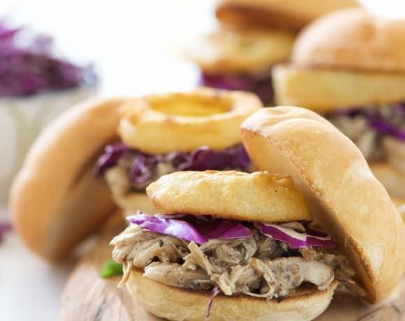 Brown Sugar Pulled Chicken Sandwiches have the most tender, slightly sweet chicken! The slow cooker makes dinner a breeze for these sliders that are topped with a tangy homemade honey mustard sauce and crispy onion rings. Perfect for dinner, get togethers or game day!