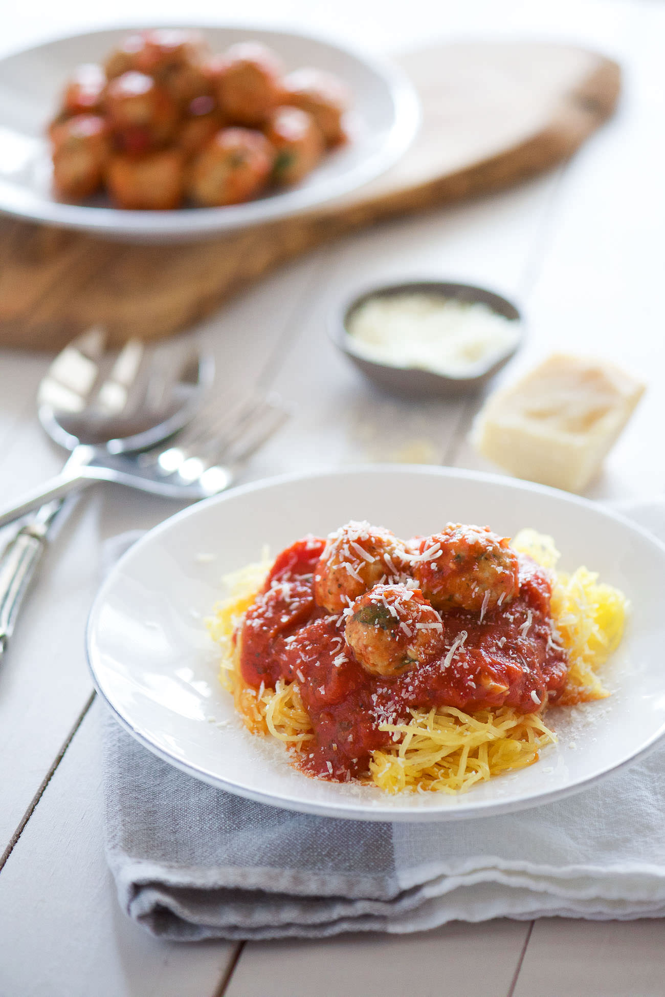 Skinny Sun Dried Tomato Meatballs with Spaghetti Squash are a light and flavorful way to cure your craving for spaghetti and meatballs! Lean ground turkey is mixed with sun dried tomatoes and spinach. Perfect to make ahead, freeze then bake before serving!